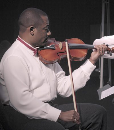 Dr. Paul Konye playing the violin