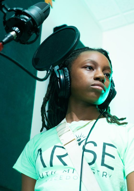 Young girl getting instruction in vocal studio