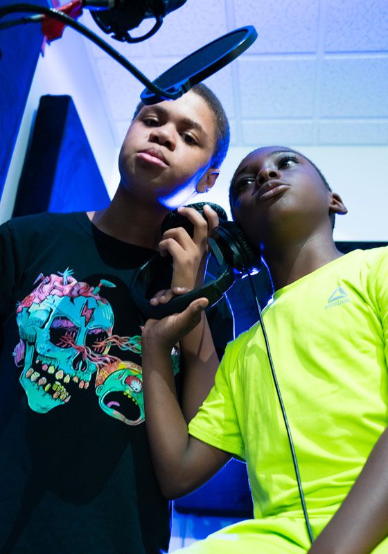 Two young boys in music recording studio